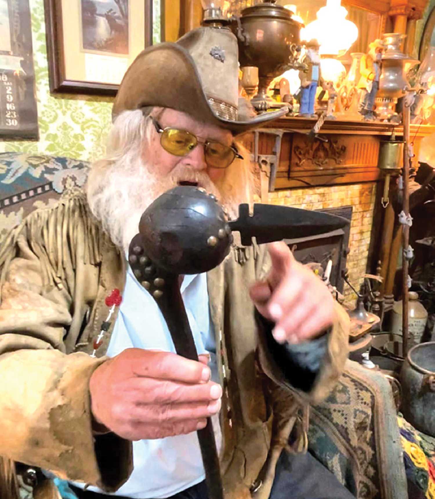 A special artifact dating back to the 1850s has been stolen from Old Georges Museum & Hidden Village, a famous roadside attraction in Whitewood. Seen here, George Chopping holds the item previous to its disappearance, a black war club embellished with brass buttons and a metal point.